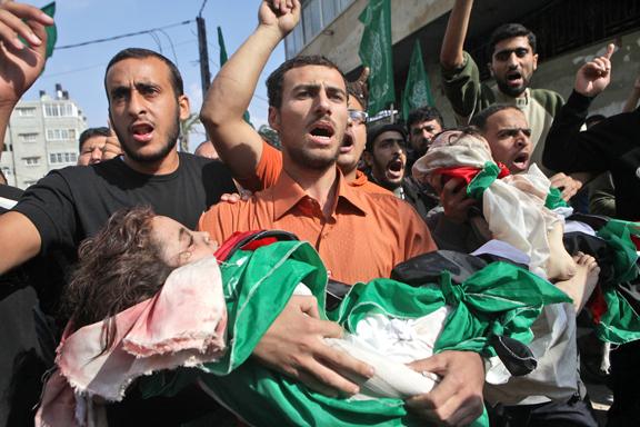 Residents of Gaza City carry the victims of the Israeli assault on Palestinians