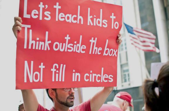 A striking teacher in Chicago protests the overtesting that dominates school curriculums
