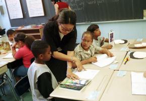 A teacher at P.S. 48 in Harlem works with students on reading skills