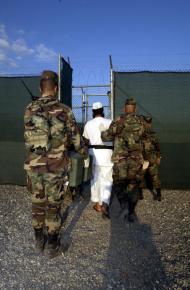 A detainee under guard at Guantánamo Bay