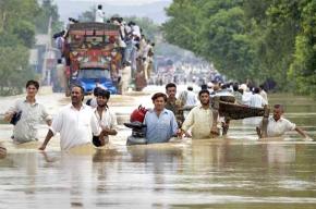 People fleeing rising floodwaters with what possessions they can carry