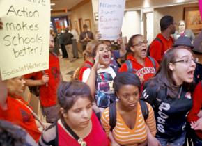 Students standing up for affirmative action make their way into a press conference