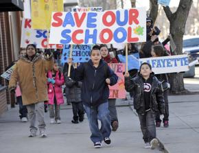 Students and parents at Lafayette Elementary School march against their school's threatened closure