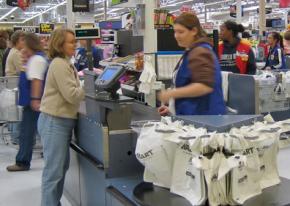 A Walmart worker at the checkout line