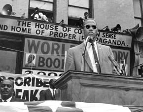 Malcolm X speaking to a crowd in Harlem