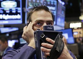 A worried trader on the floor of the New York Stock Exchange