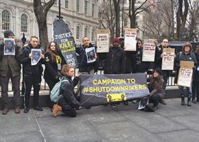 Protesters call for the Rikers Island jail to be shut down at a protest outside City Hall