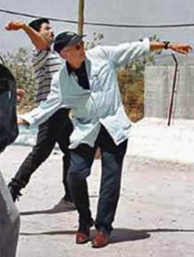 The late Edward Said casts a symbolic stone of resistance toward Israel from Lebanon