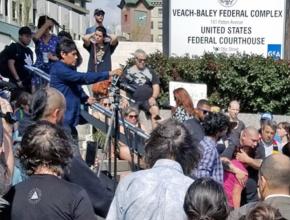 Activists gather at the Asheville Federal Building to denounce ICE raids