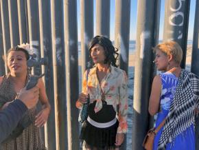 Members of the migrant caravan reach the U.S.-Mexico border in Tijuana